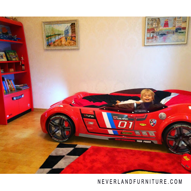 Little baby boy loves his car bed from Neverland Furniture